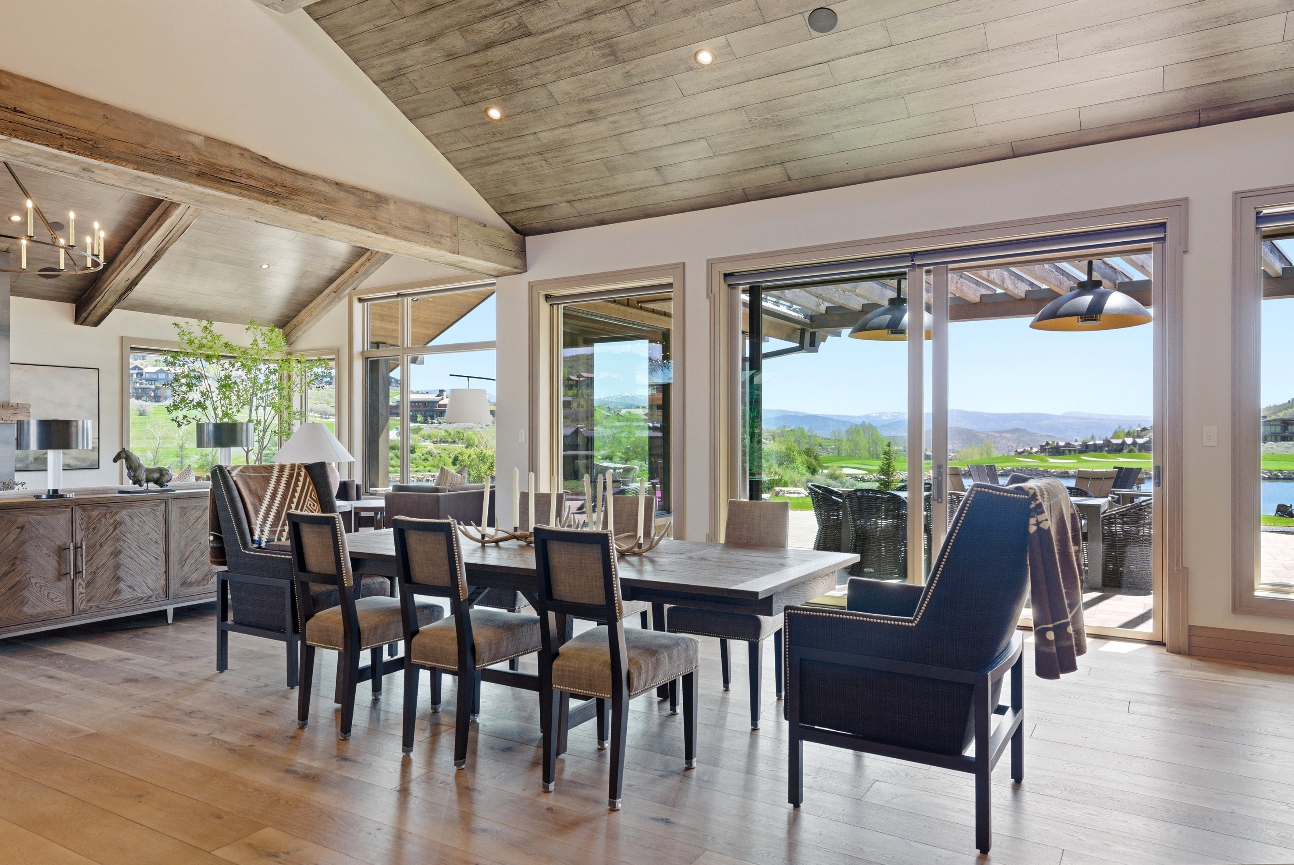 Dining area featuring a vaulted ceiling with wood-finish planks and exposed beams
