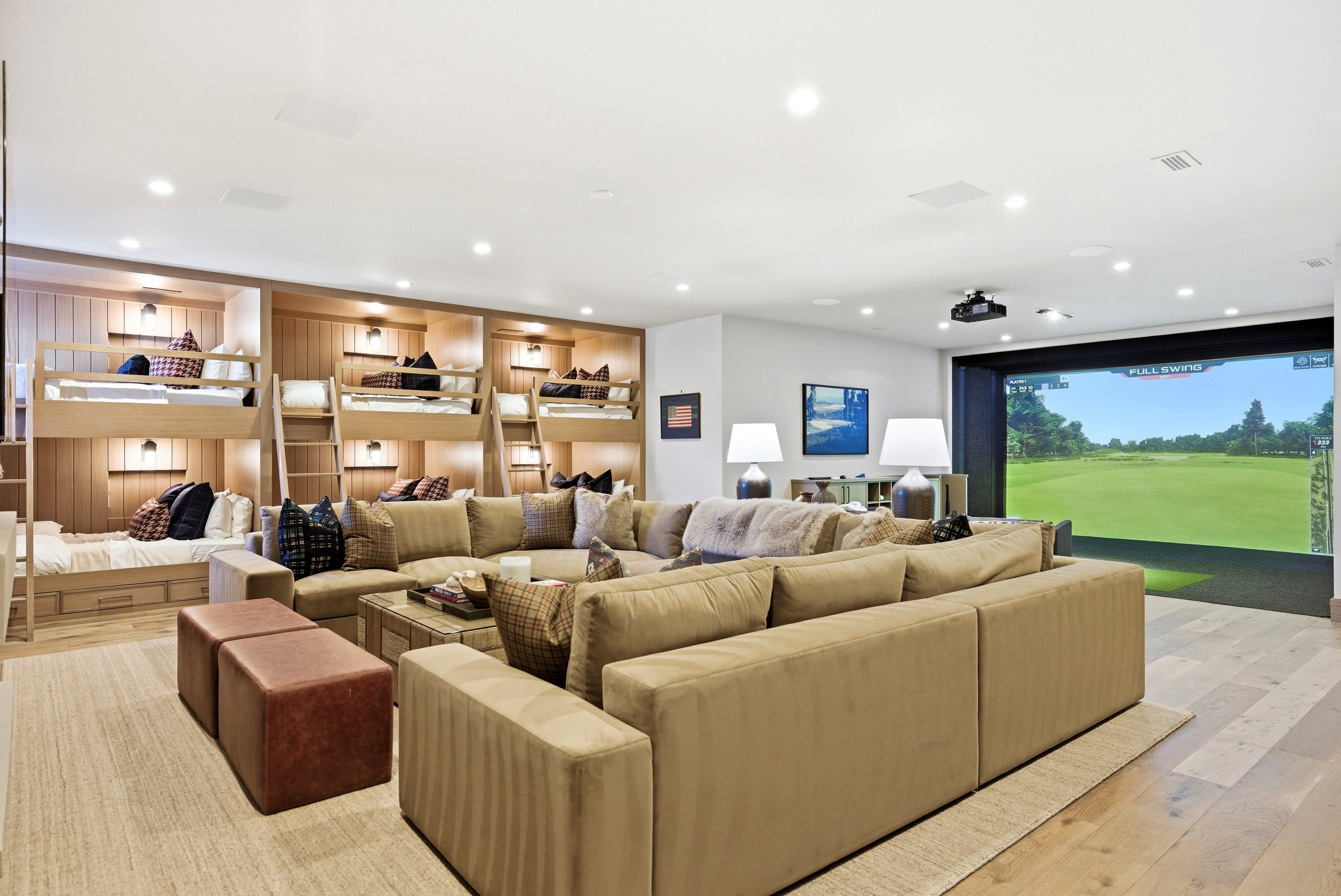 Entertainment room featuring a built-in golf simulator screen and a projector
