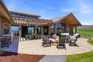 Expansive paver patio with a built-in stone fire pit