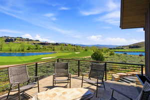 Spacious outdoor patio with tiled flooring and a contemporary metal railing