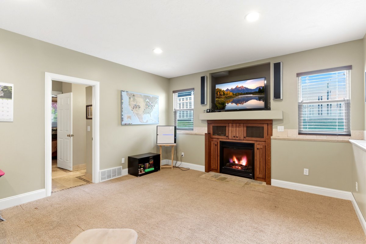 Built-in media center featuring a fireplace with a wood surround and hearth