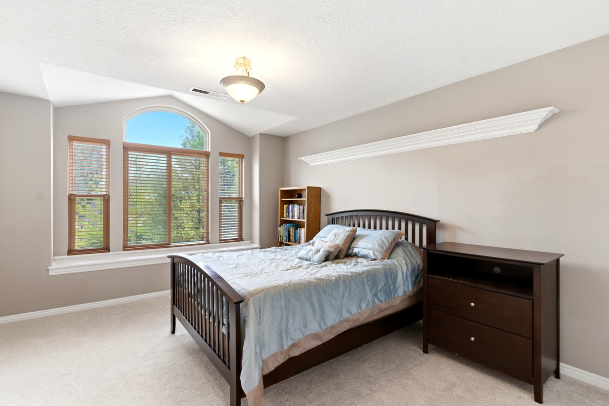 Arched and rectangular windows with wood blinds, providing exterior views