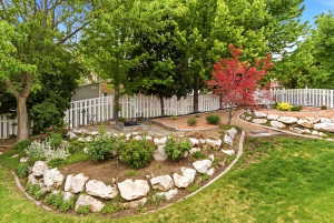 Terraced garden with natural stone retaining walls and mature trees