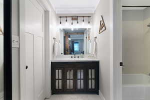 Modern bathroom featuring a dark wood-finish vanity with mesh inserts, a white countertop, and a large mirror
