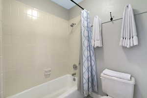 Bathroom with white tiled shower surround and tub