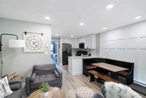Open-concept living area with recessed lighting and light wood-finish flooring