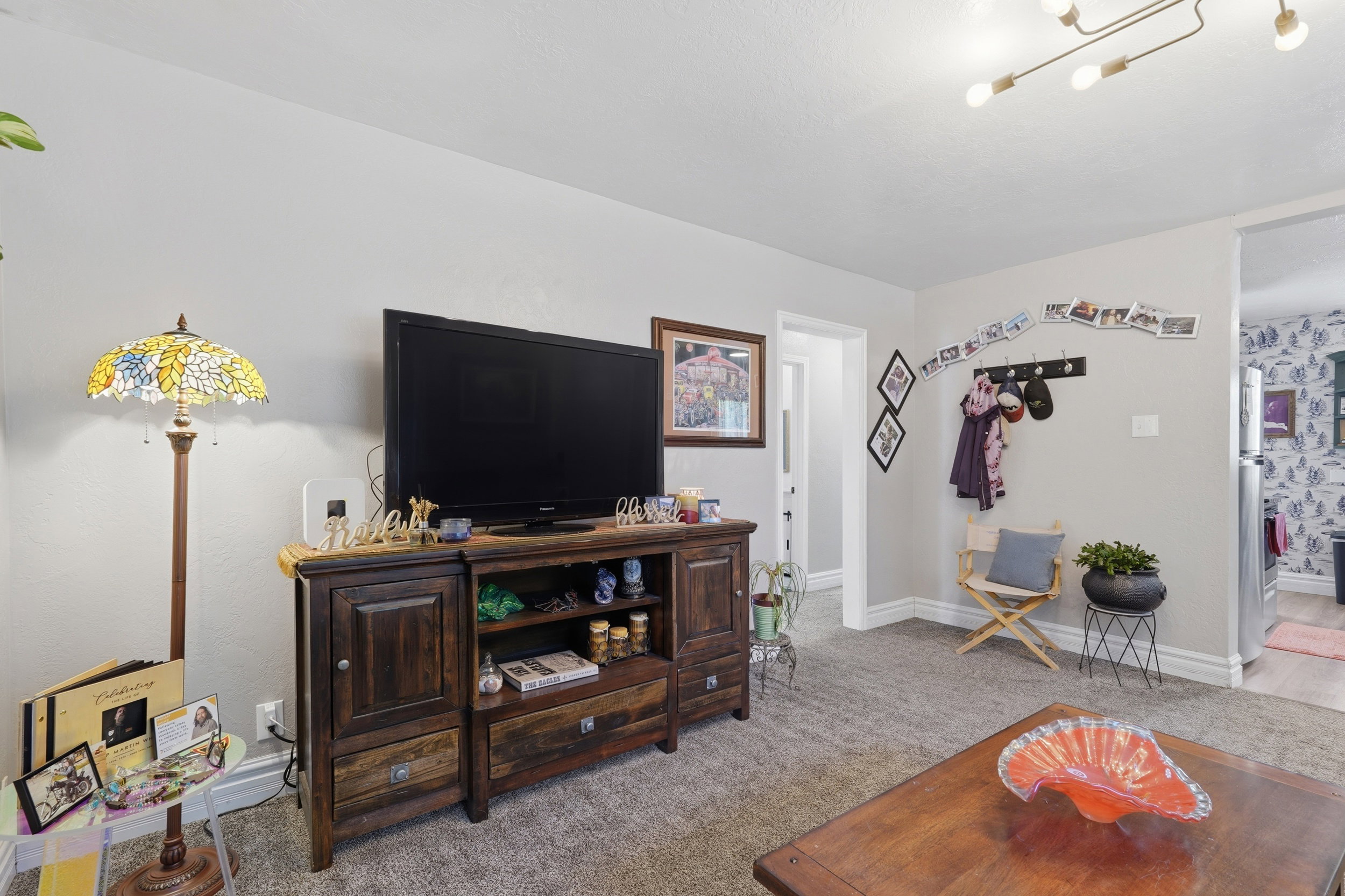 Interior living space featuring light gray wall paint, dark wood-finish trim, and a modern ceiling light fixture