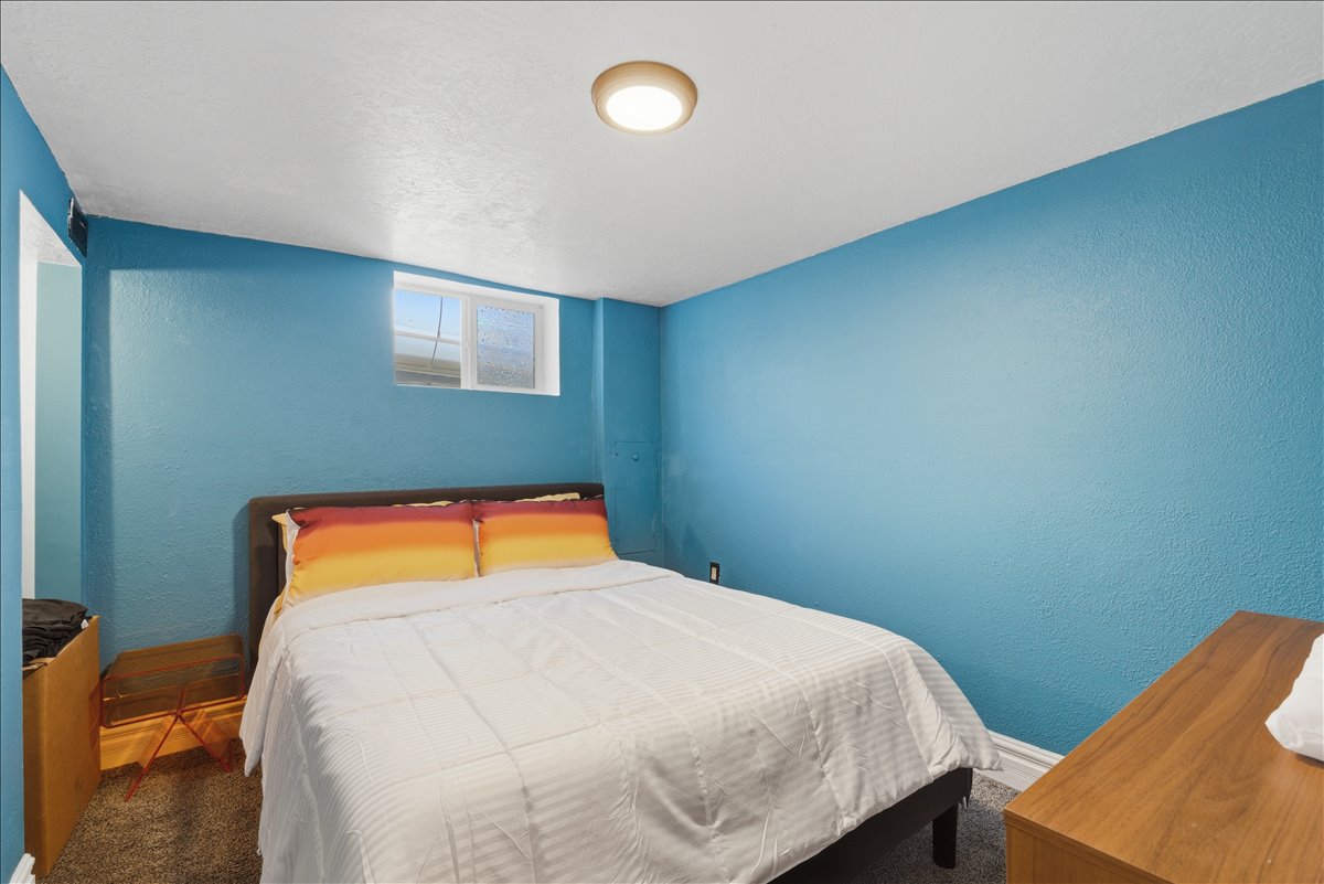 Bedroom 4, with old bedroom. Featuring textured blue walls, white ceiling, and a flush-mount ceiling light fixture