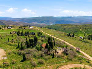 Expansive rural landscape featuring rolling hills and distant mountains