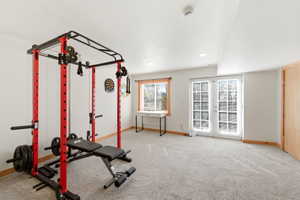 Versatile bonus room featuring light gray carpet flooring, white walls, and recessed lighting