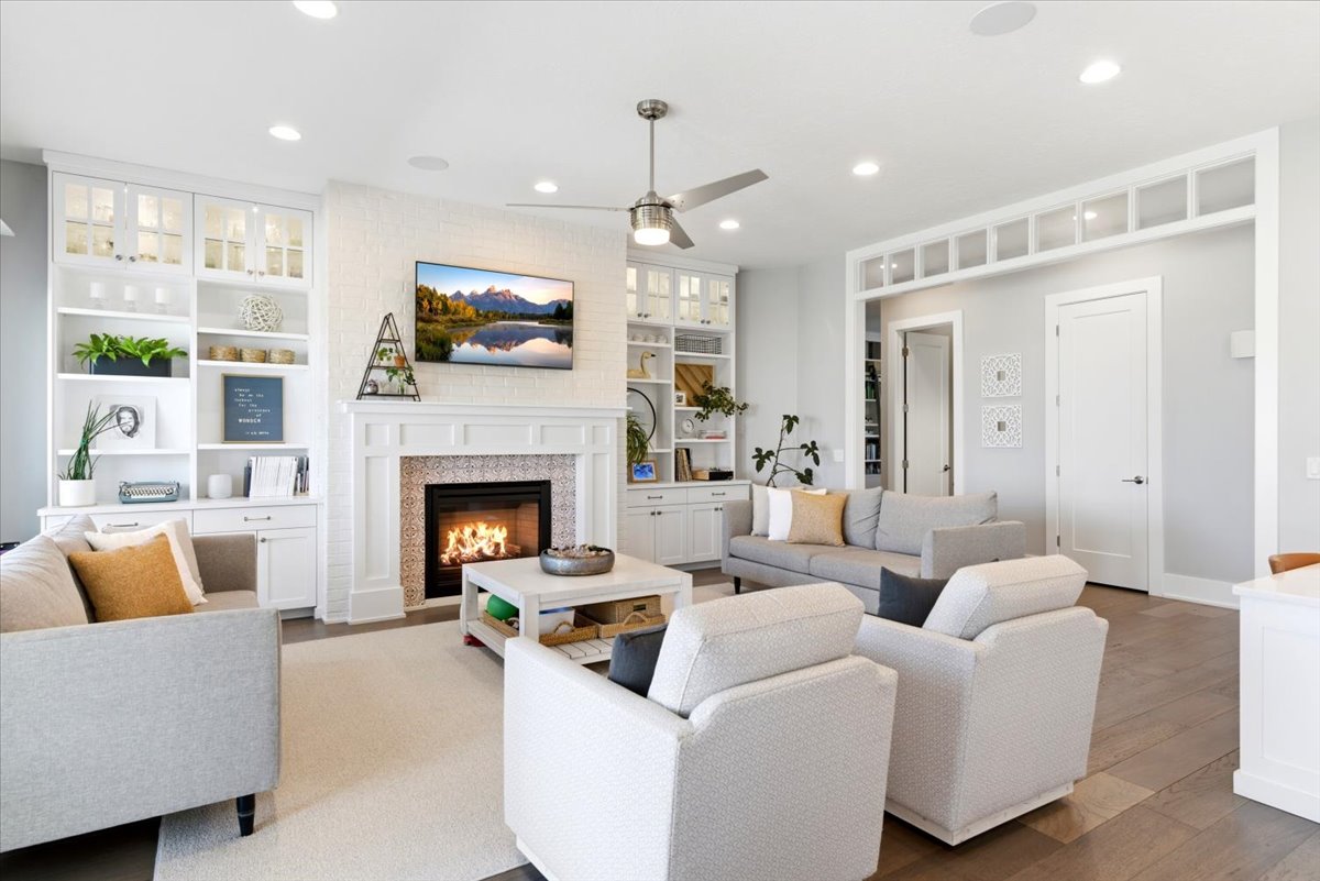 Living area featuring a white brick-surround fireplace with decorative tile work and a classic mantel