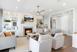 Living area featuring a white brick-surround fireplace with decorative tile work and a classic mantel