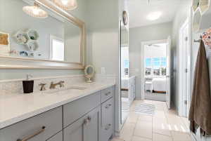 Vanity featuring an integrated sink, light-toned countertop, and a tiled backsplash