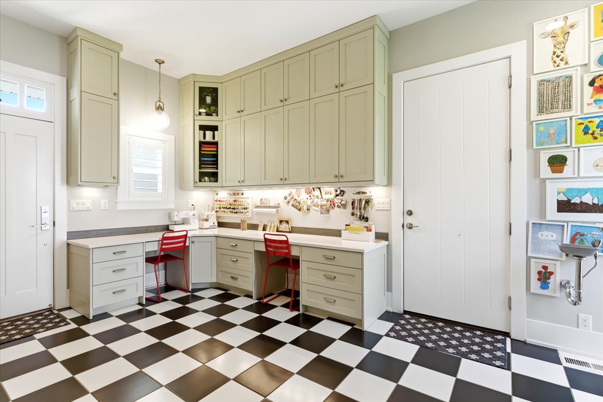 Craft room featuring extensive built-in cabinetry, under-cabinet lighting, and a white countertop
