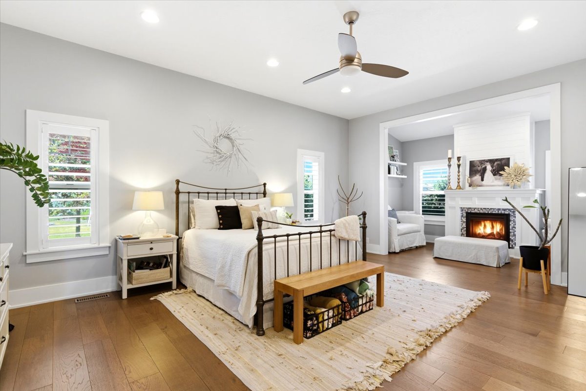 Hardwood flooring throughout featuring a ceiling fan, recessed lighting, and white plantation shutters on windows