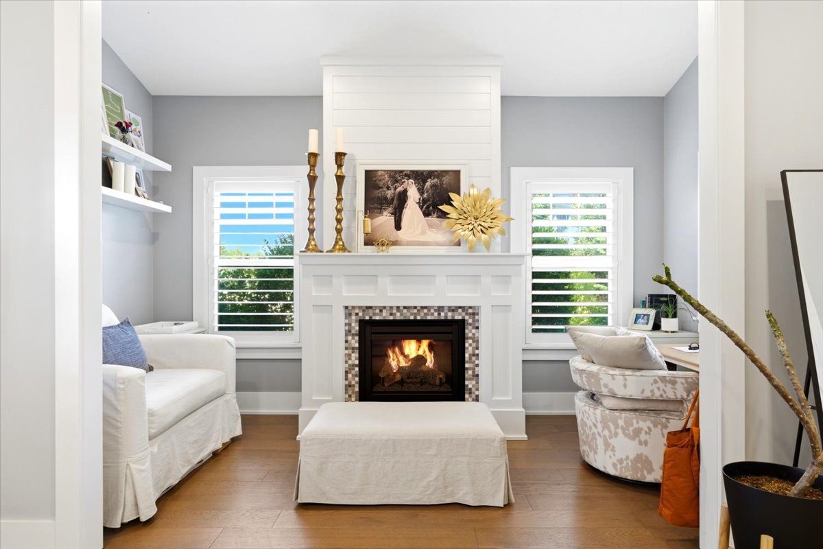 Living area featuring a central fireplace with mosaic tile surround and shiplap detailing