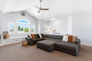 Vaulted ceiling with an overhead fan and recessed lighting