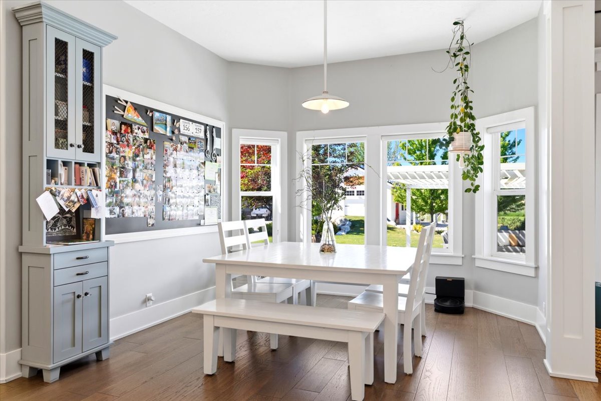 Bright dining area featuring wood-finish flooring