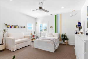 Bright interior space featuring white walls and a ceiling fan with integrated lighting