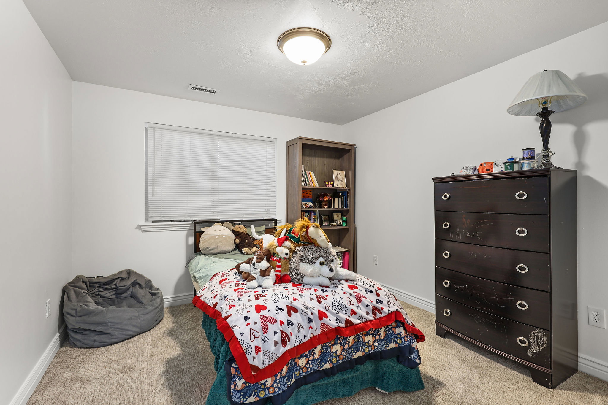 Bedroom featuring neutral carpeting and white walls