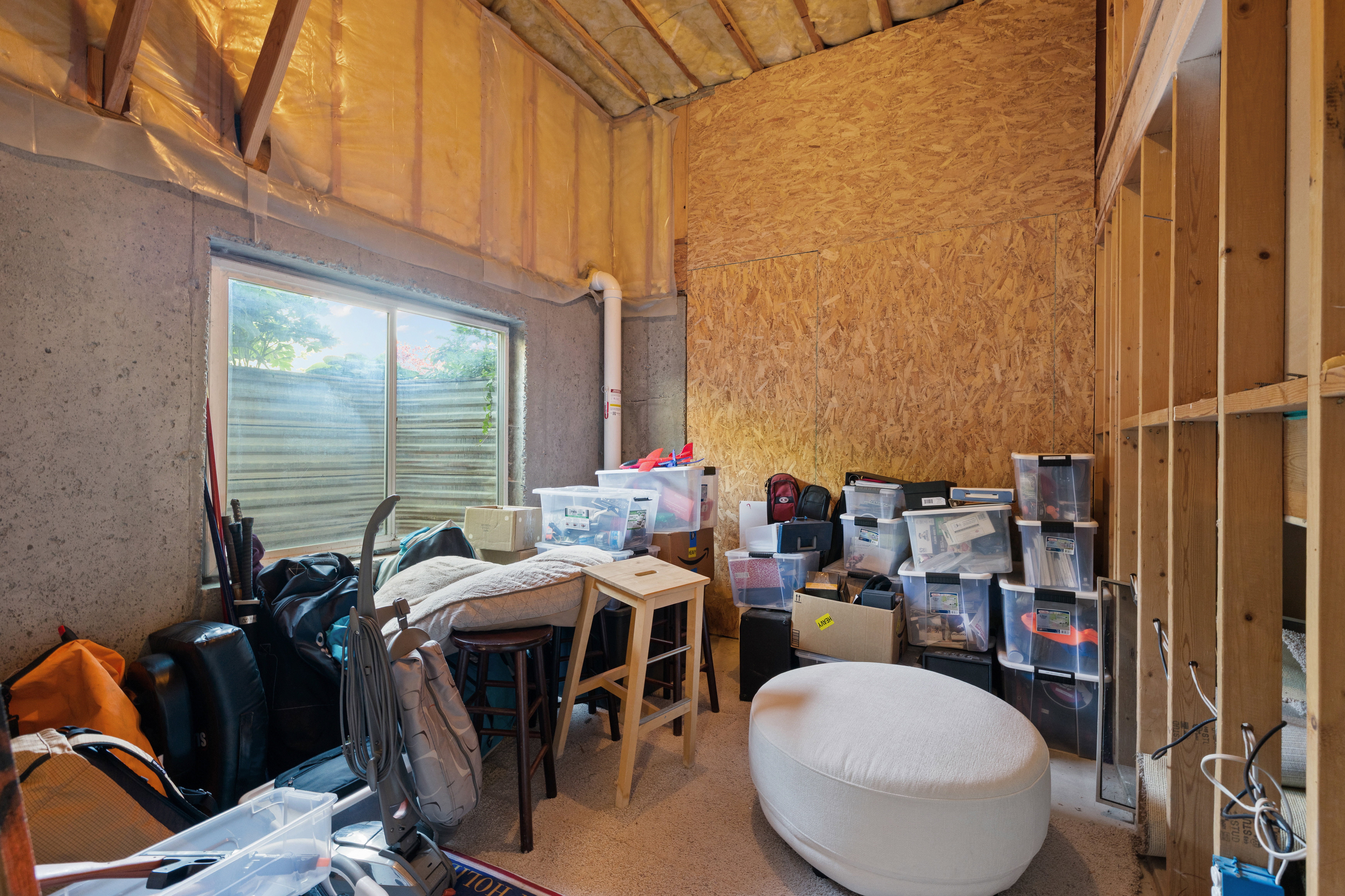 Unfinished room in lower level w/  high ceilings