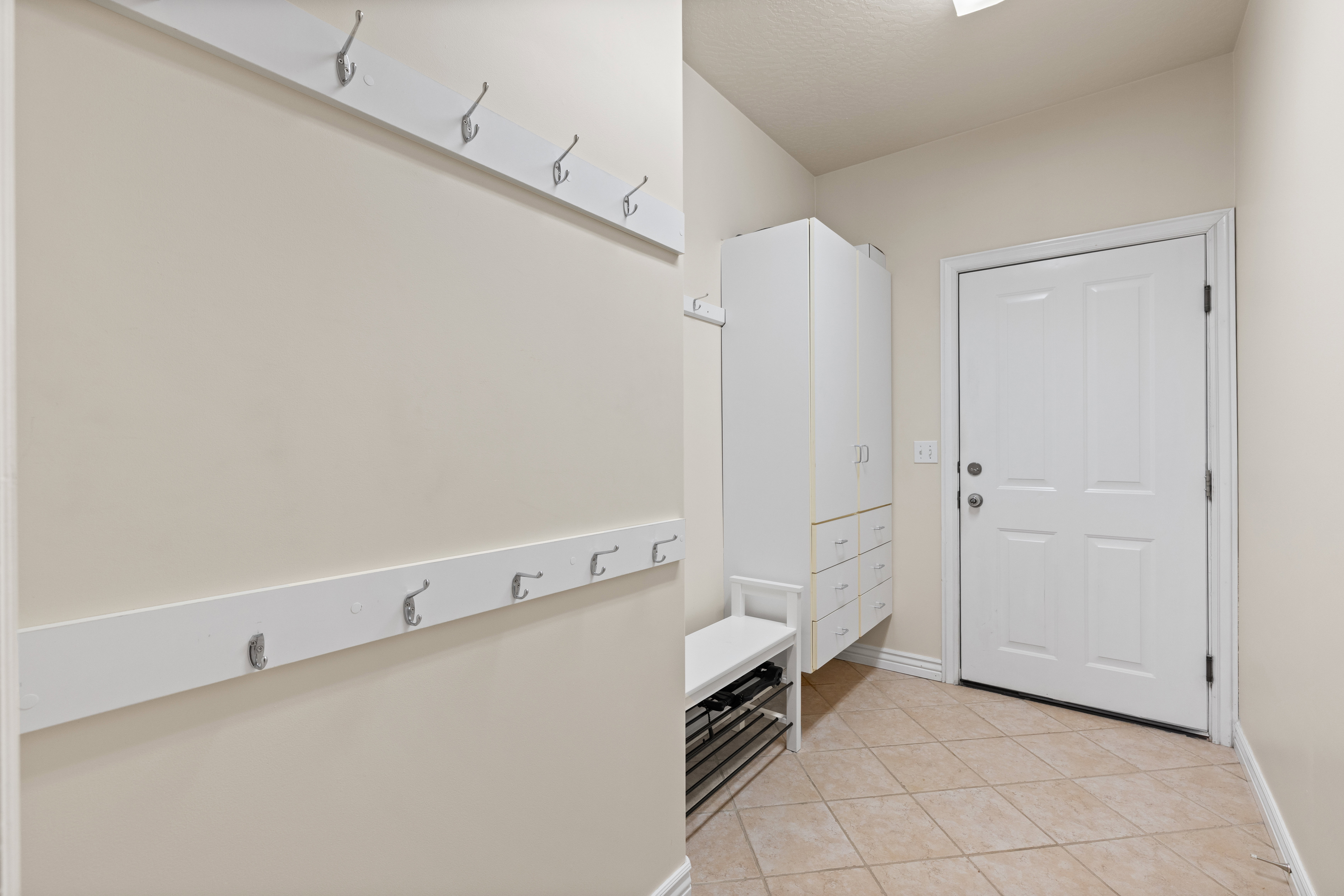 Mud room with cabinets and bench