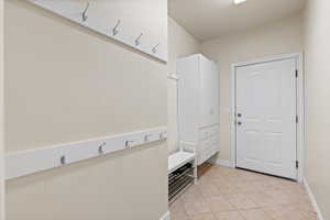 Mud room with cabinets and bench