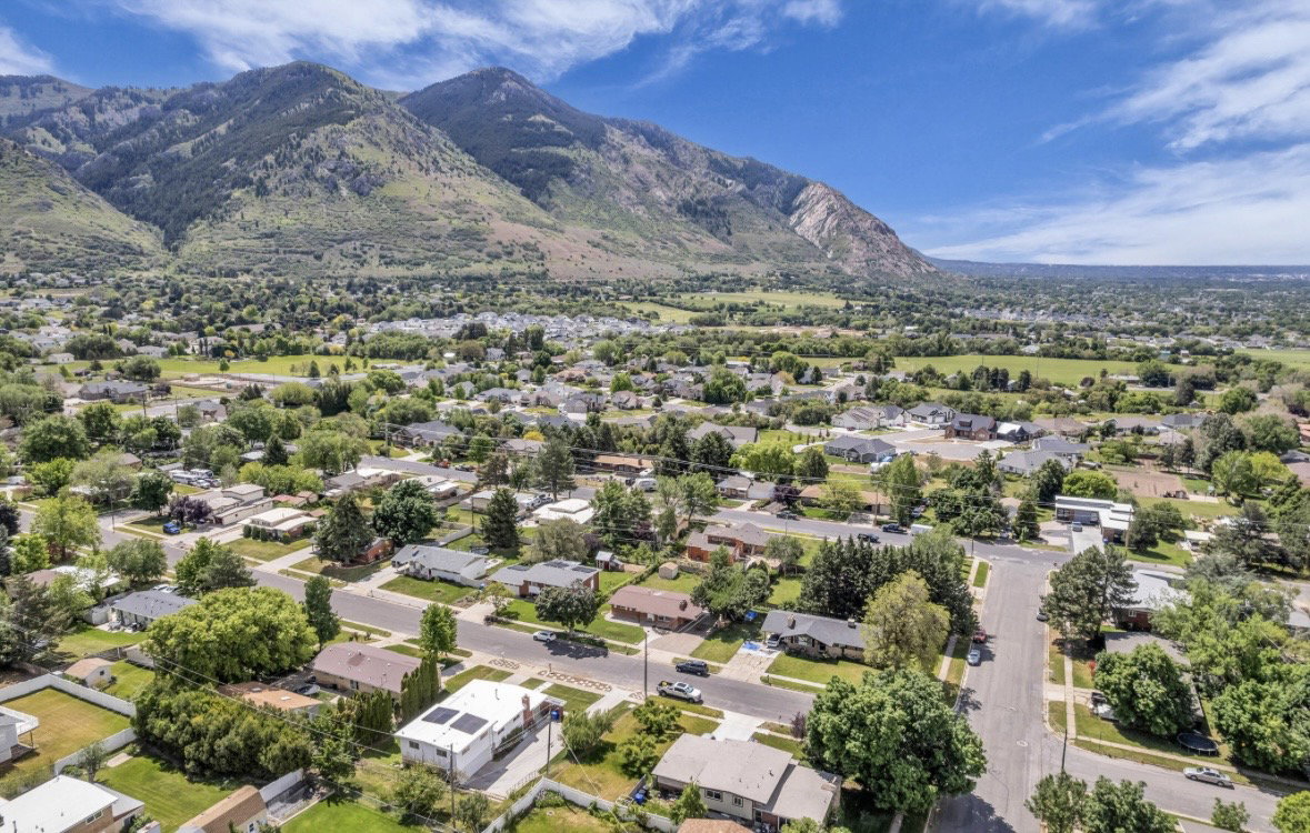 Aerial perspective showcasing a residential neighborhood with a prominent mountain backdrop