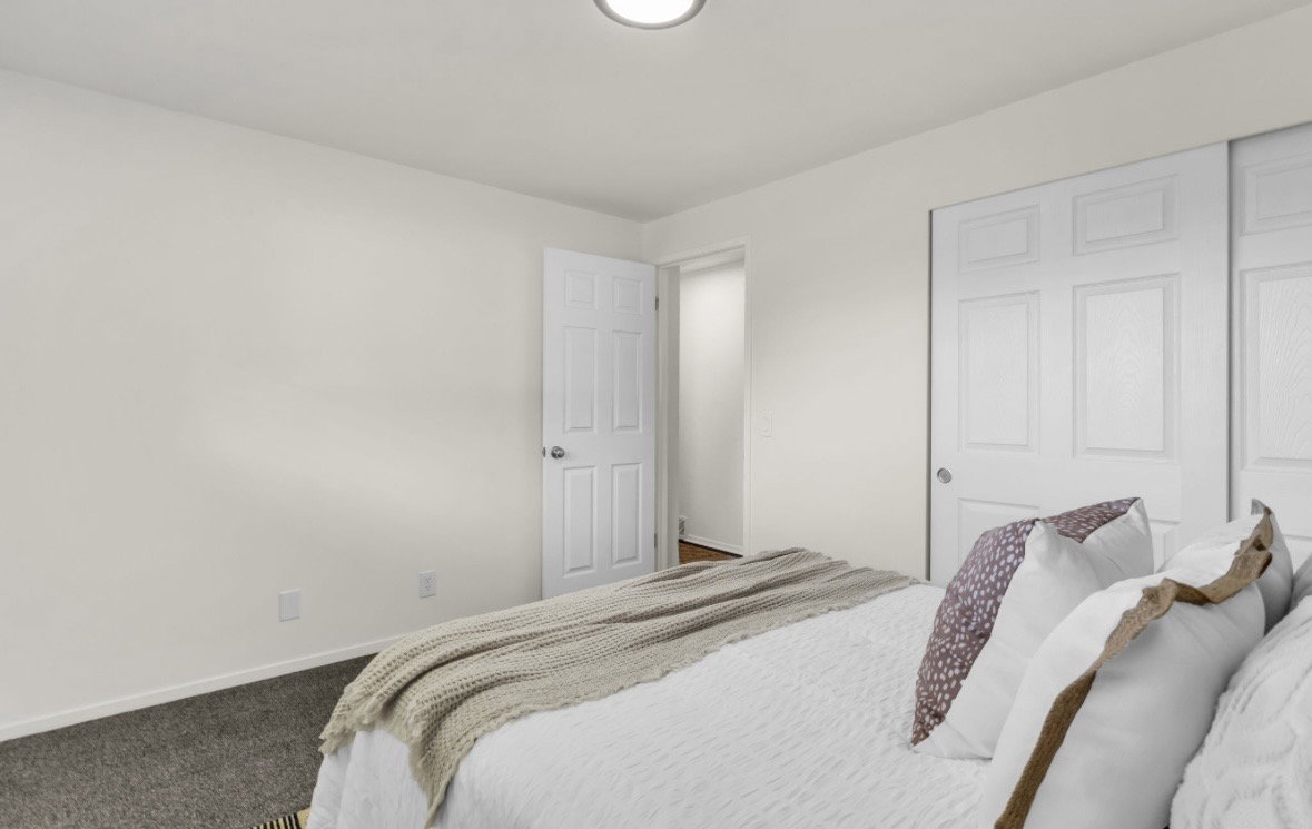 Bedroom featuring light-toned walls, recessed lighting, and dark carpet flooring