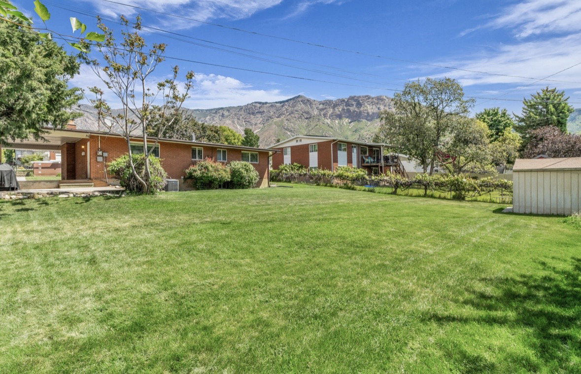 Expansive green lawn with mountain backdrop