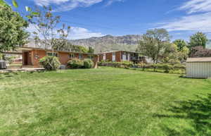 Expansive green lawn with mountain backdrop