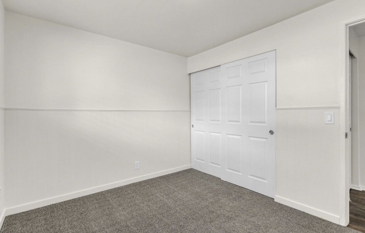 Interior space featuring light gray carpet flooring and white baseboards