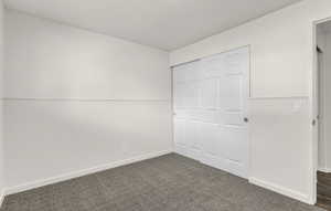 Interior space featuring light gray carpet flooring and white baseboards