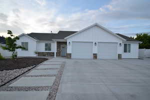 Modern farmhouse exterior with white board and batten siding and stone accents
