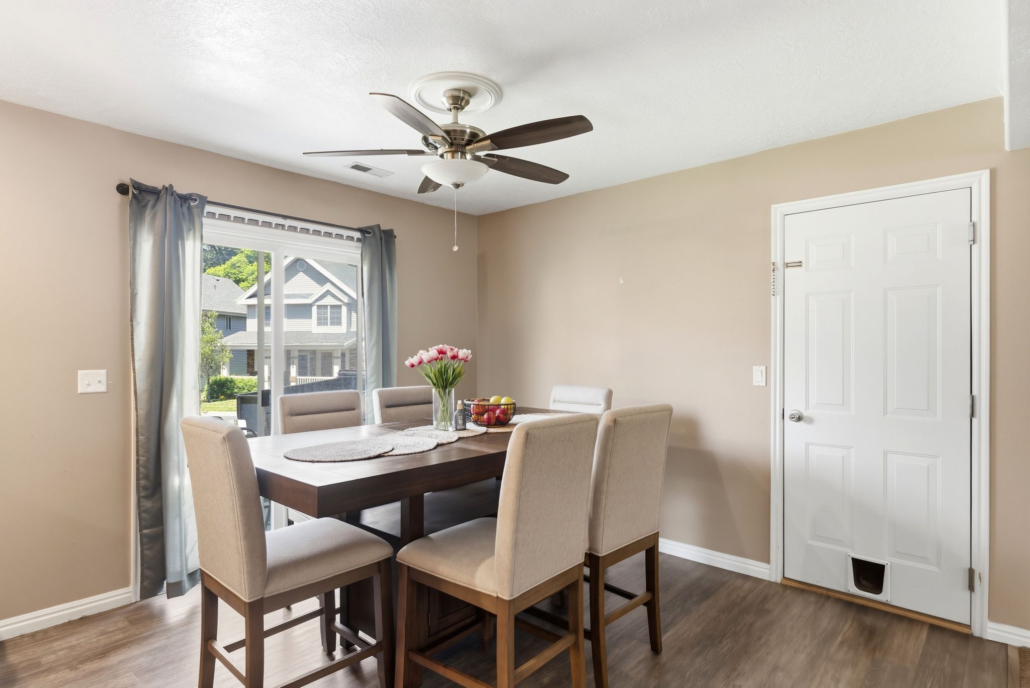 Dining area featuring wood-finish flooring and a ceiling fan with integrated lighting
