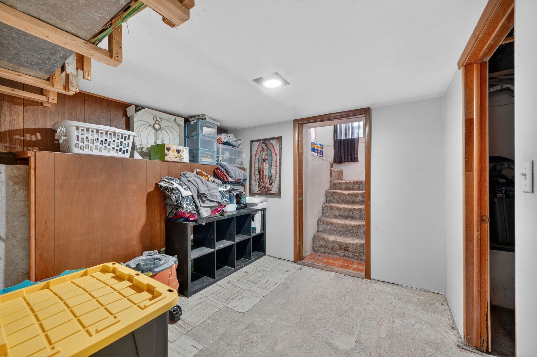 Lower level space featuring painted white walls and a concrete floor