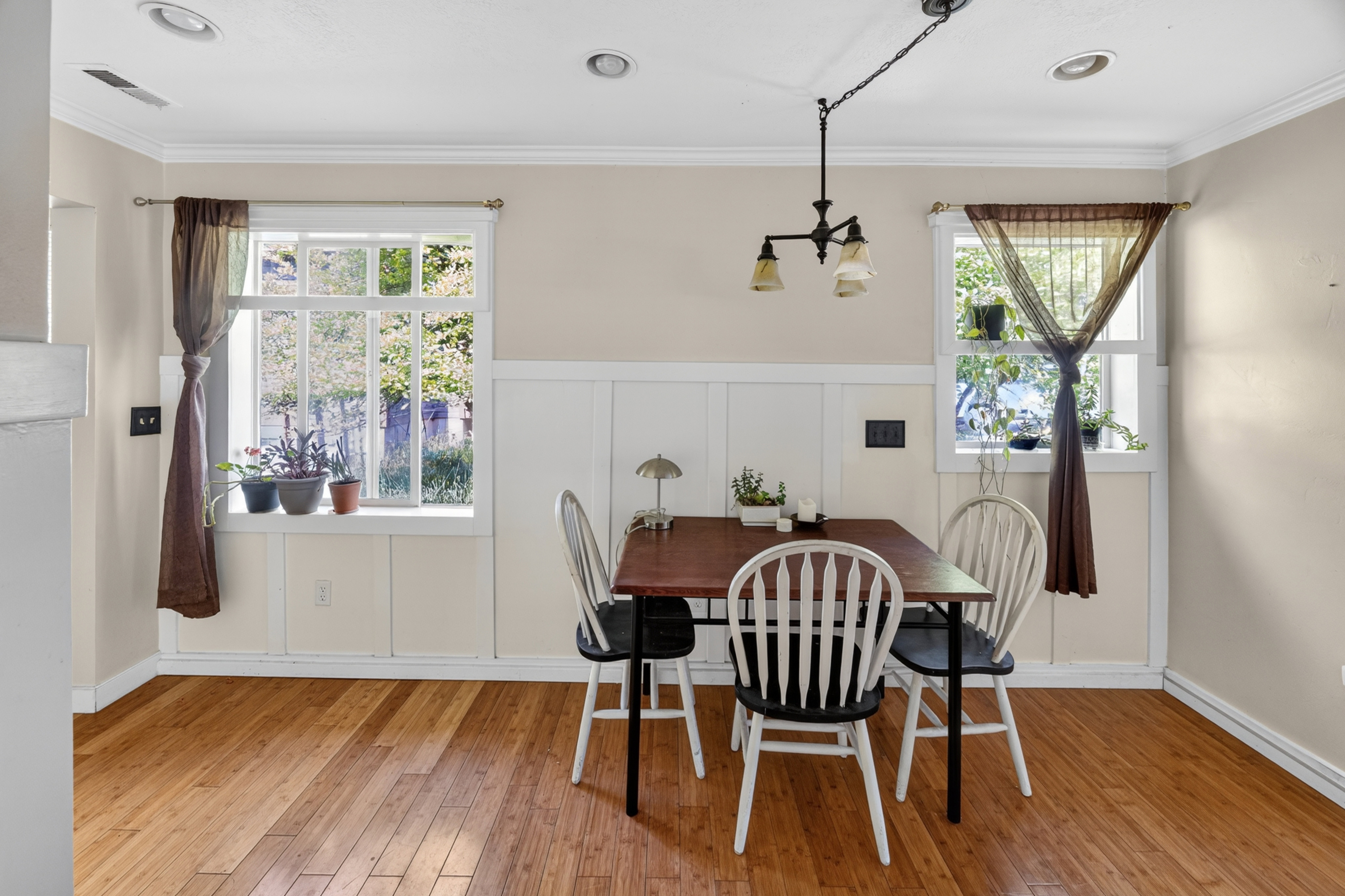 Hardwood flooring throughout featuring white board and batten wall detailing
