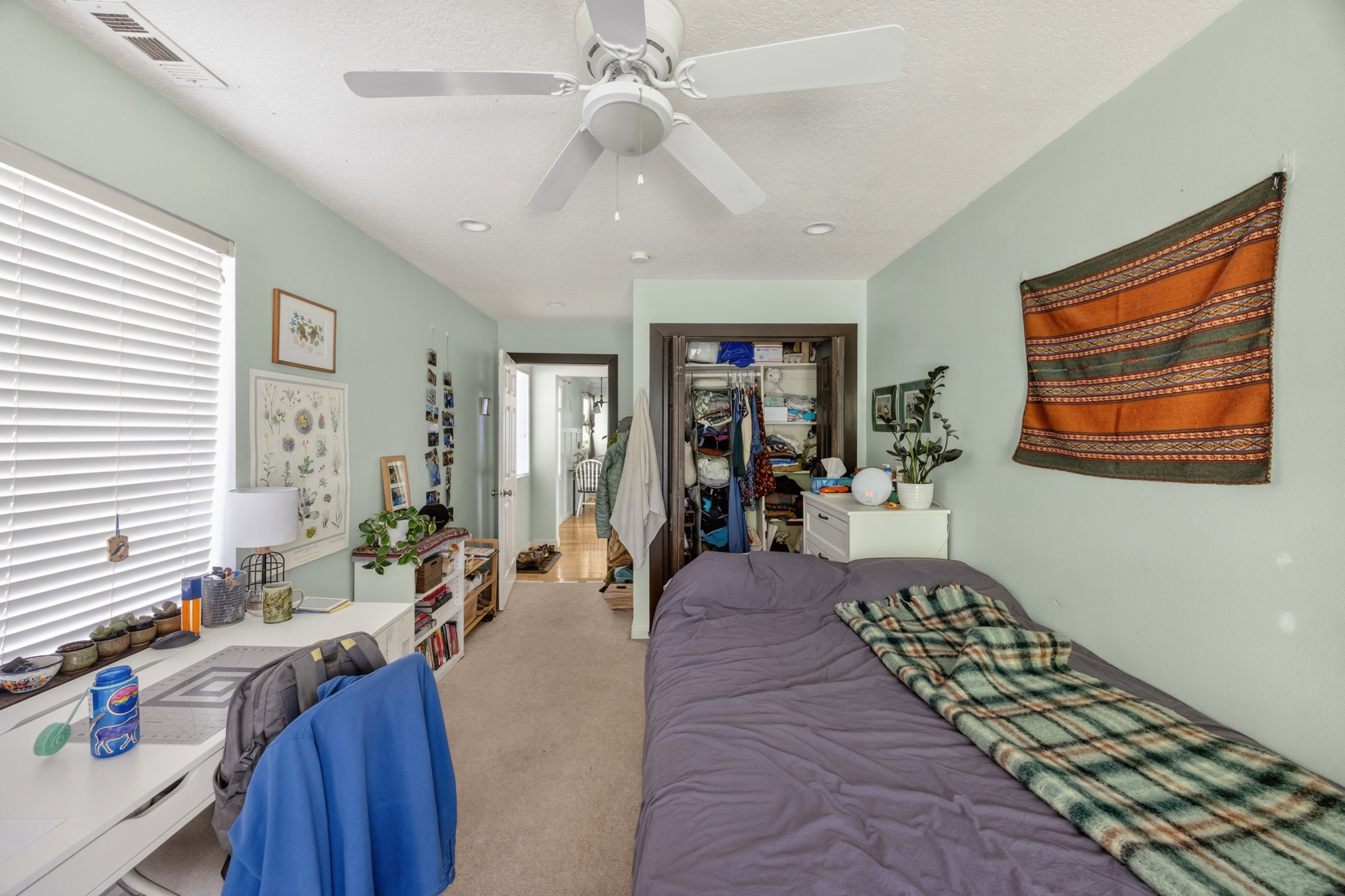 Bedroom featuring neutral carpeting, a ceiling fan, recessed lighting, a window with horizontal blinds, and a built-in closet with dark trim