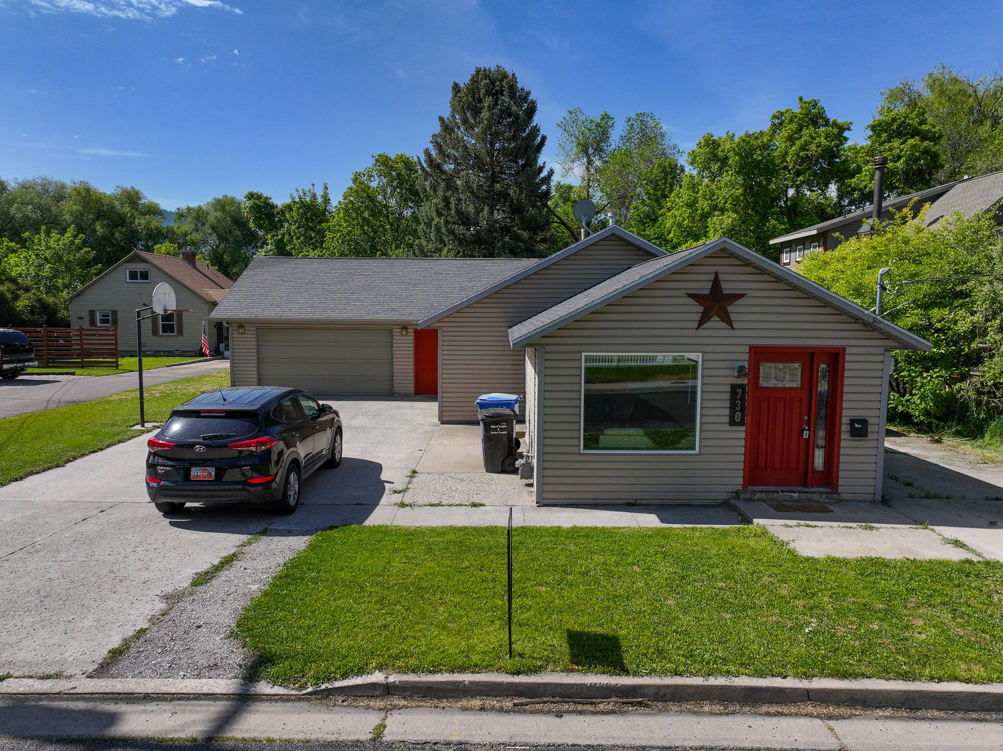 Front exterior with light-colored siding and a contrasting red entry door