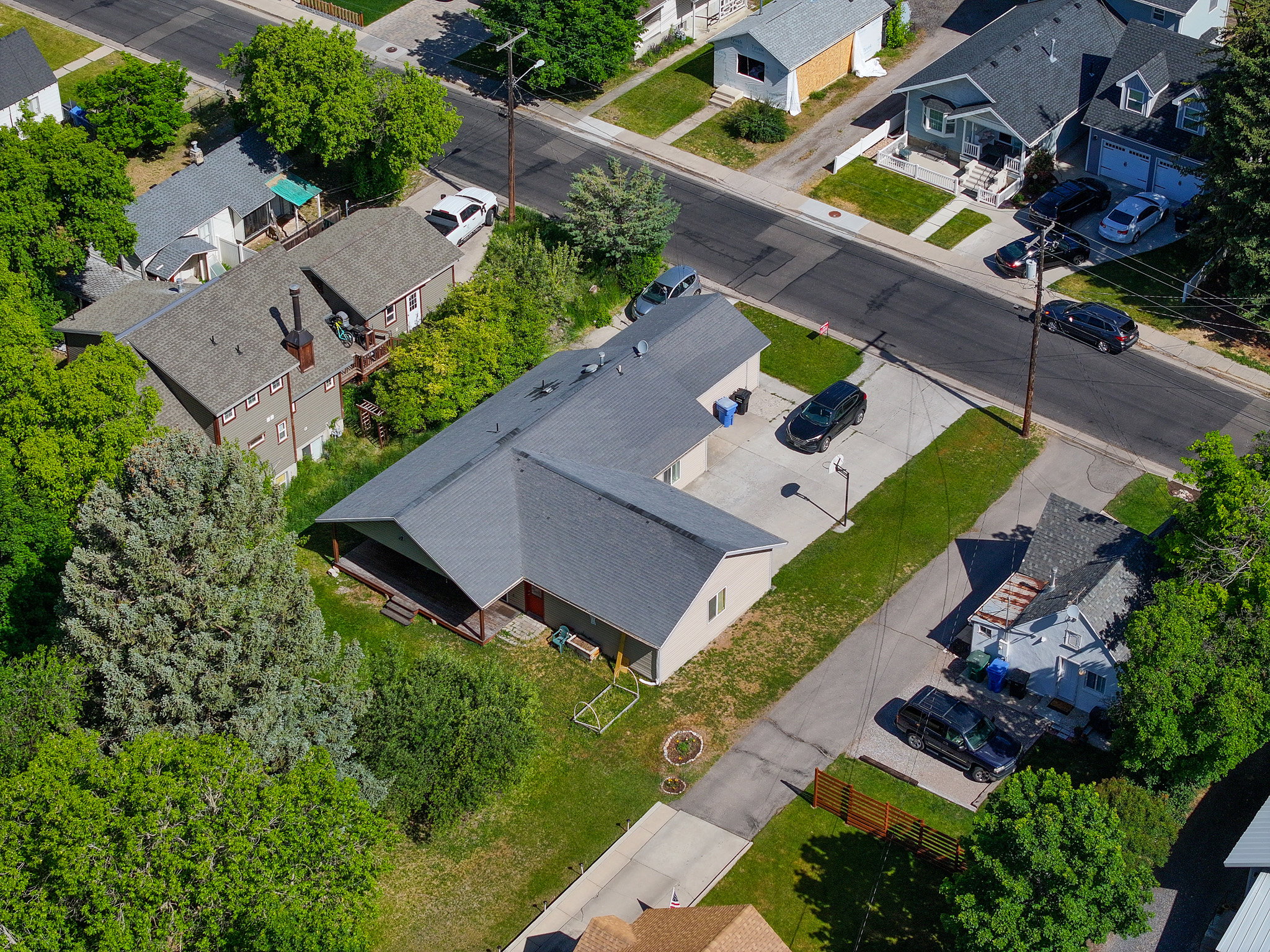Single-story residence featuring a gray shingle roof and light-colored siding
