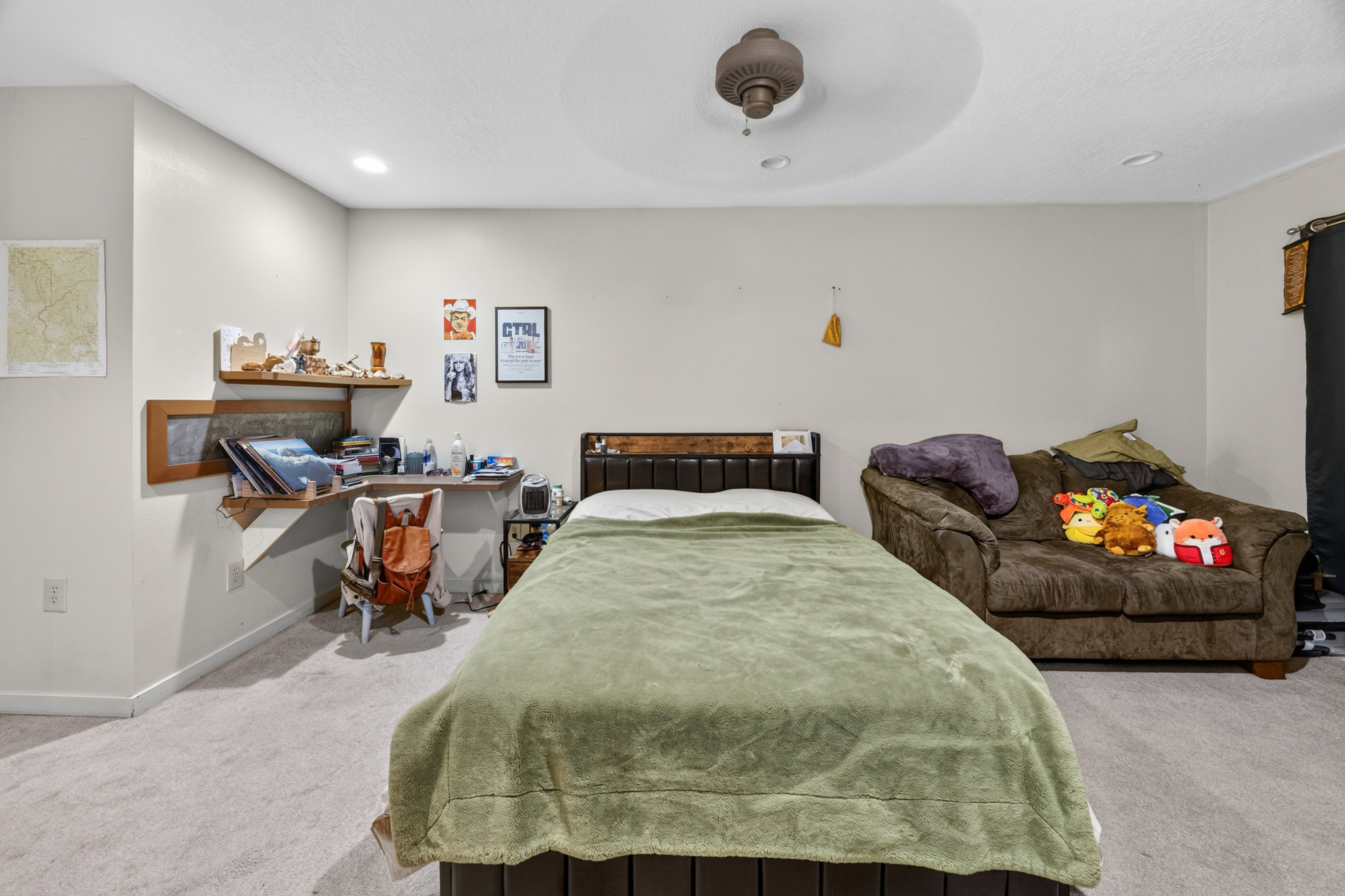 Carpeted room featuring a ceiling fan, recessed lighting, and a built-in wood-finish corner desk