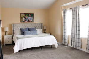 Oversized primary bedroom featuring tons of natural light. Sky high vaulted ceilings.