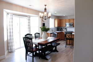 Dining area with beautiful lighting and access to the backyard.