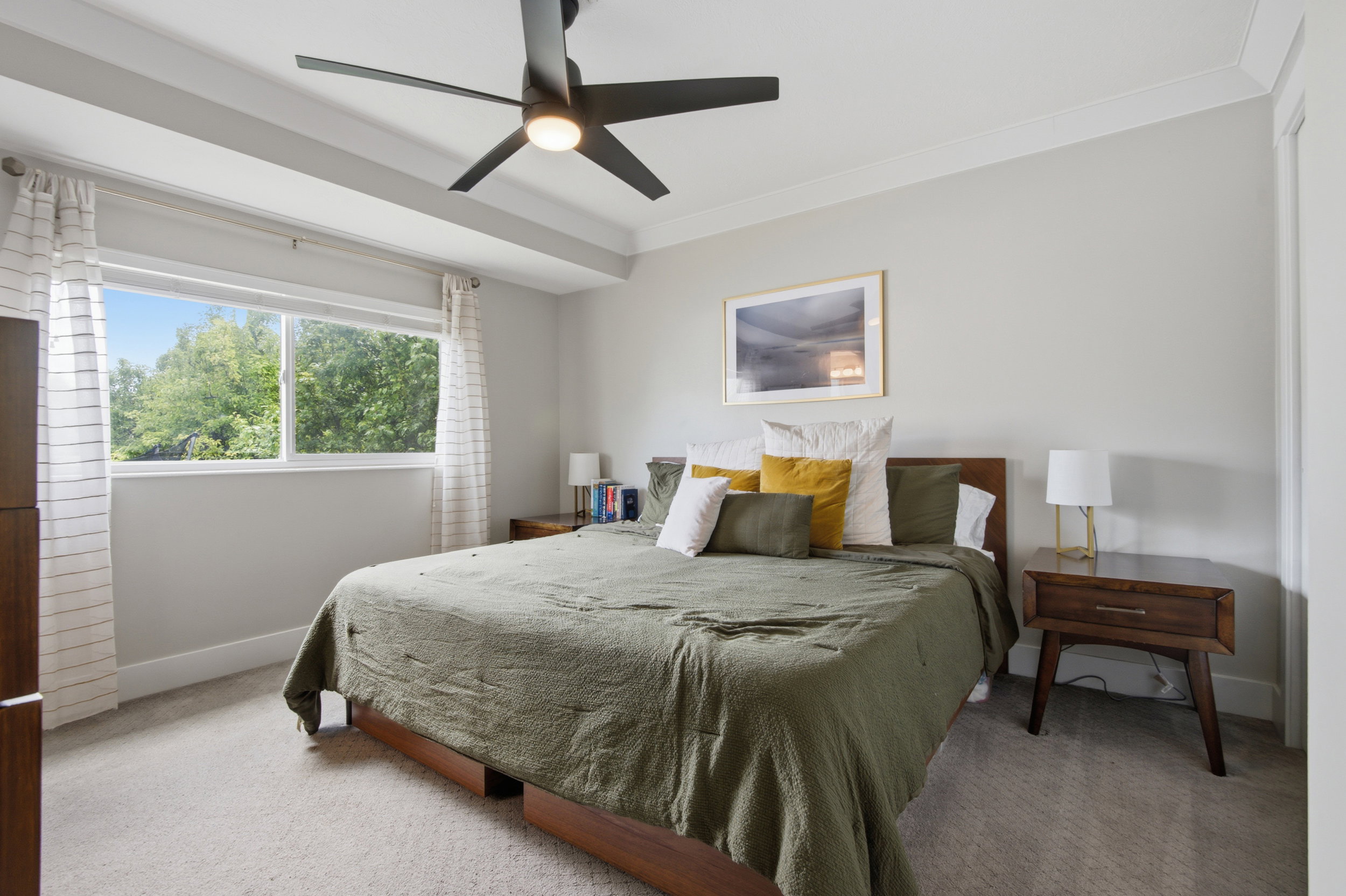 Recessed ceiling with layered trim molding, a contemporary ceiling fan with integrated lighting, and light gray wall paint