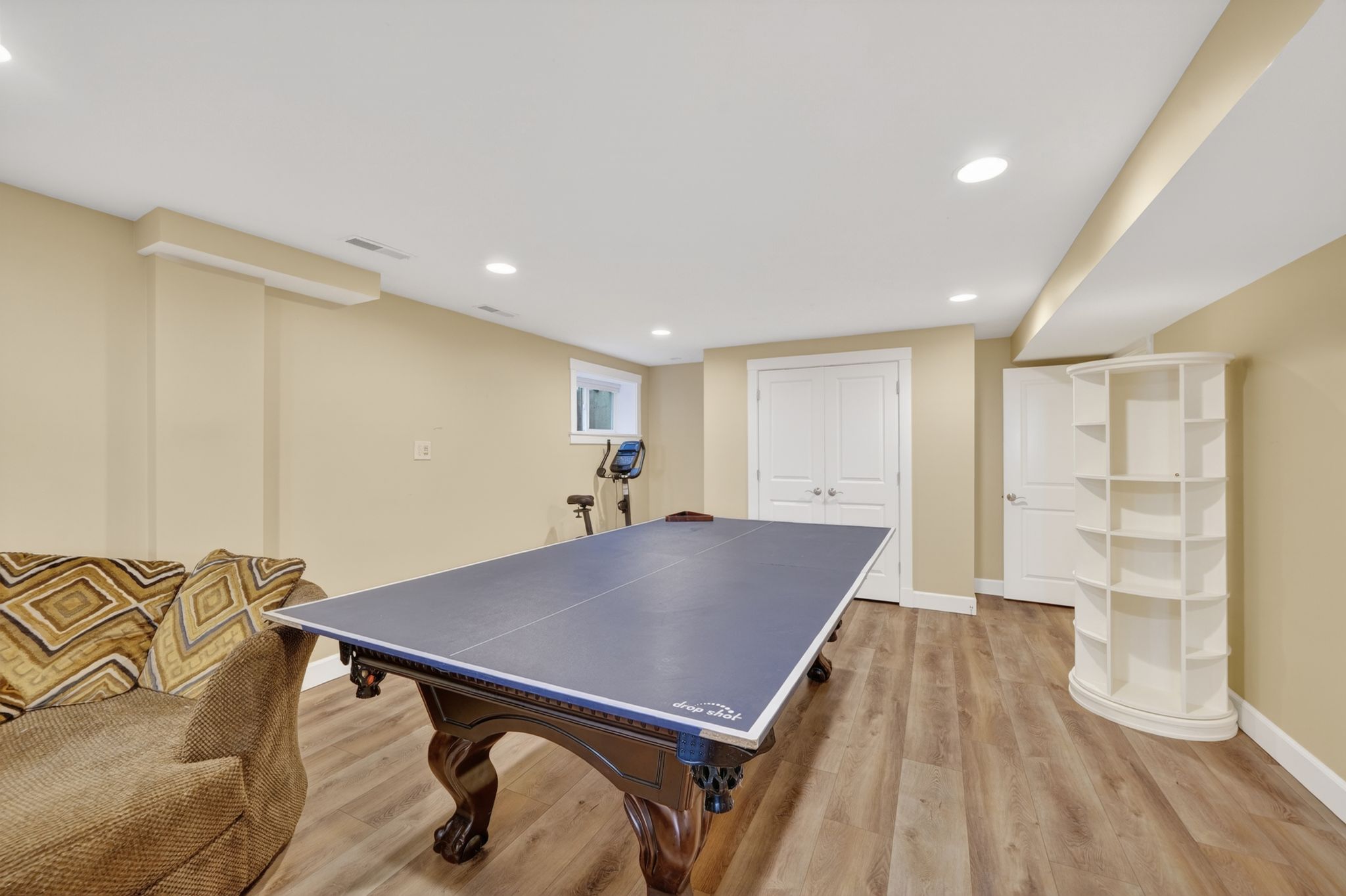 Spacious lower level featuring wood-finish flooring, recessed lighting, and a neutral color palette