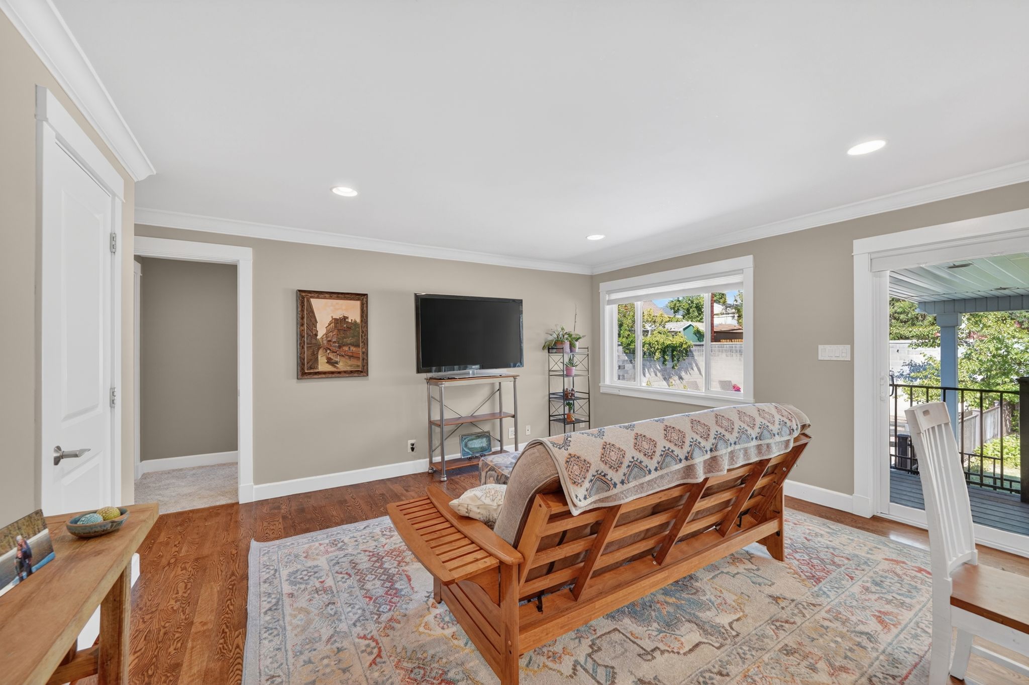 Living area featuring wood-finish flooring, recessed lighting, and a neutral wall palette