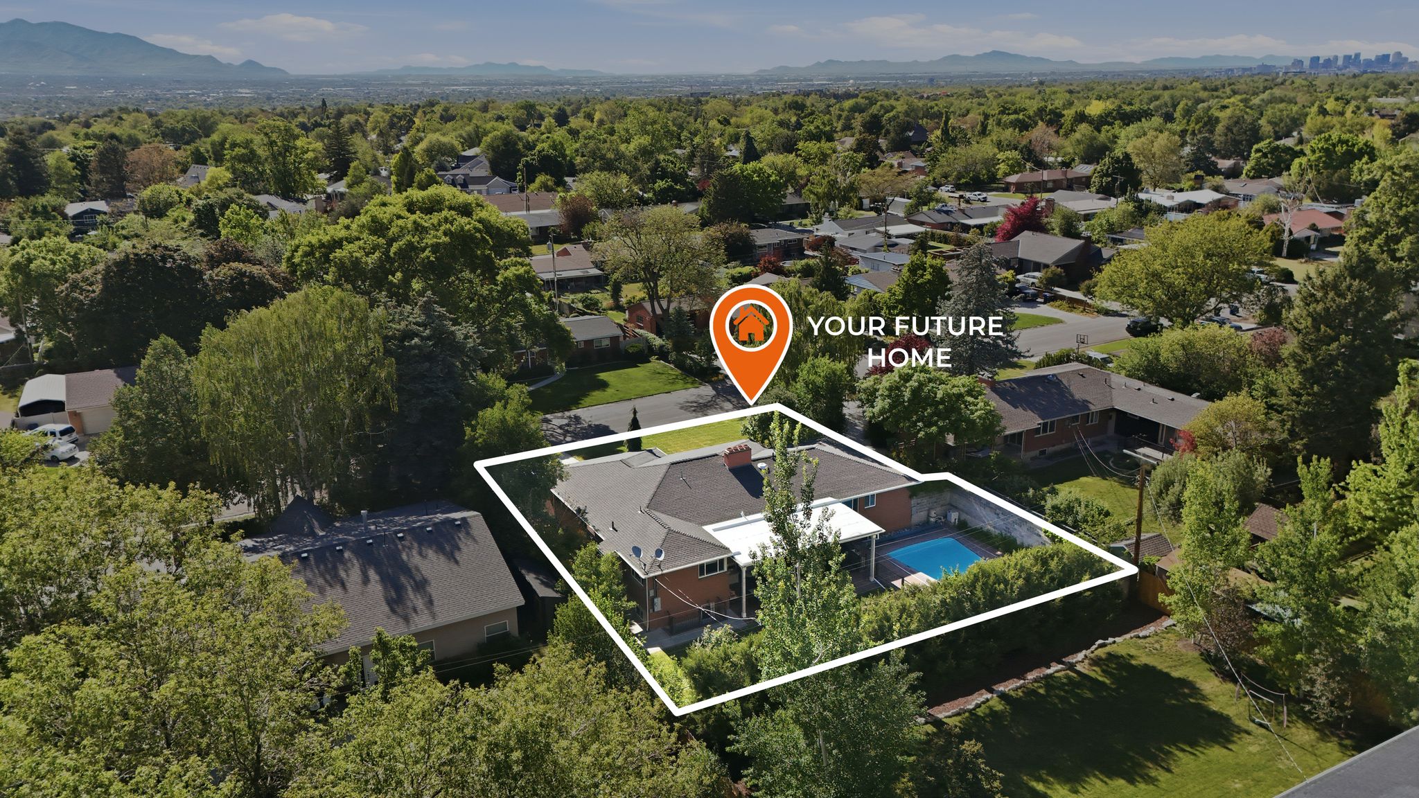 Aerial view of a residential property with a private swimming pool, surrounded by mature trees