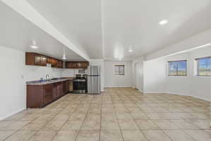 Open-concept space featuring ceramic tile flooring and recessed lighting