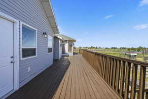 Expansive wood-finish deck featuring a full perimeter railing