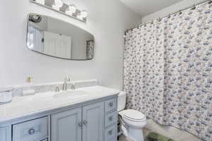 Bathroom vanity featuring light blue cabinetry with brushed nickel hardware, a white countertop with an undermount sink, and a brushed nickel widespread faucet